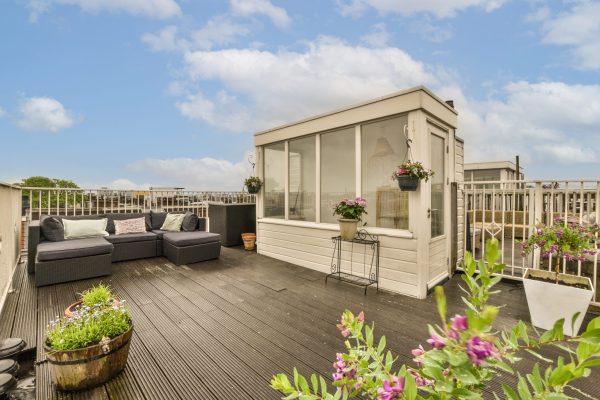 a roof deck with flowers and potted plants in the fore - image was taken from an outside viewing point SSUCv3H4sIAAAAAAAACpySz26DMAzG75P2DijnIqXAKOxVqh2cxIWoaVIlodNU9d2XP4Cy6274Z/uzv5jn+1tVEQZOcvJZPWMUYqnU4rwFL40OmB5WblELtCV52LanJQBZRiikN1aCKiEDz2cNNwxQL0pF/EpJ4jz4xaGLu6yIg8cpaGS4S+SFzzmutkRKho6QIuRQMLewxDaUxf/VmT++dsMTav6TFi6MWFQI2cg5l5Lrt0d7K63BIqQpXD0MBxUL2kIJ5B0s/Om7W8mlngpi/Jzusilxs2hv41a7GaKMuQNT8dUvYQxufAbnQrnYeDGbh7/A3Io52vjkaVUlIhwnhse2bQfaf4xjQxs69F2/FuSDzjLopHU2oRDzqxSlKxk3IMej6BlemvqEFOvuJMZ6FN1Q01awhnFs+NCFW7x+AQAA//8DAAtDnPG5AgAA